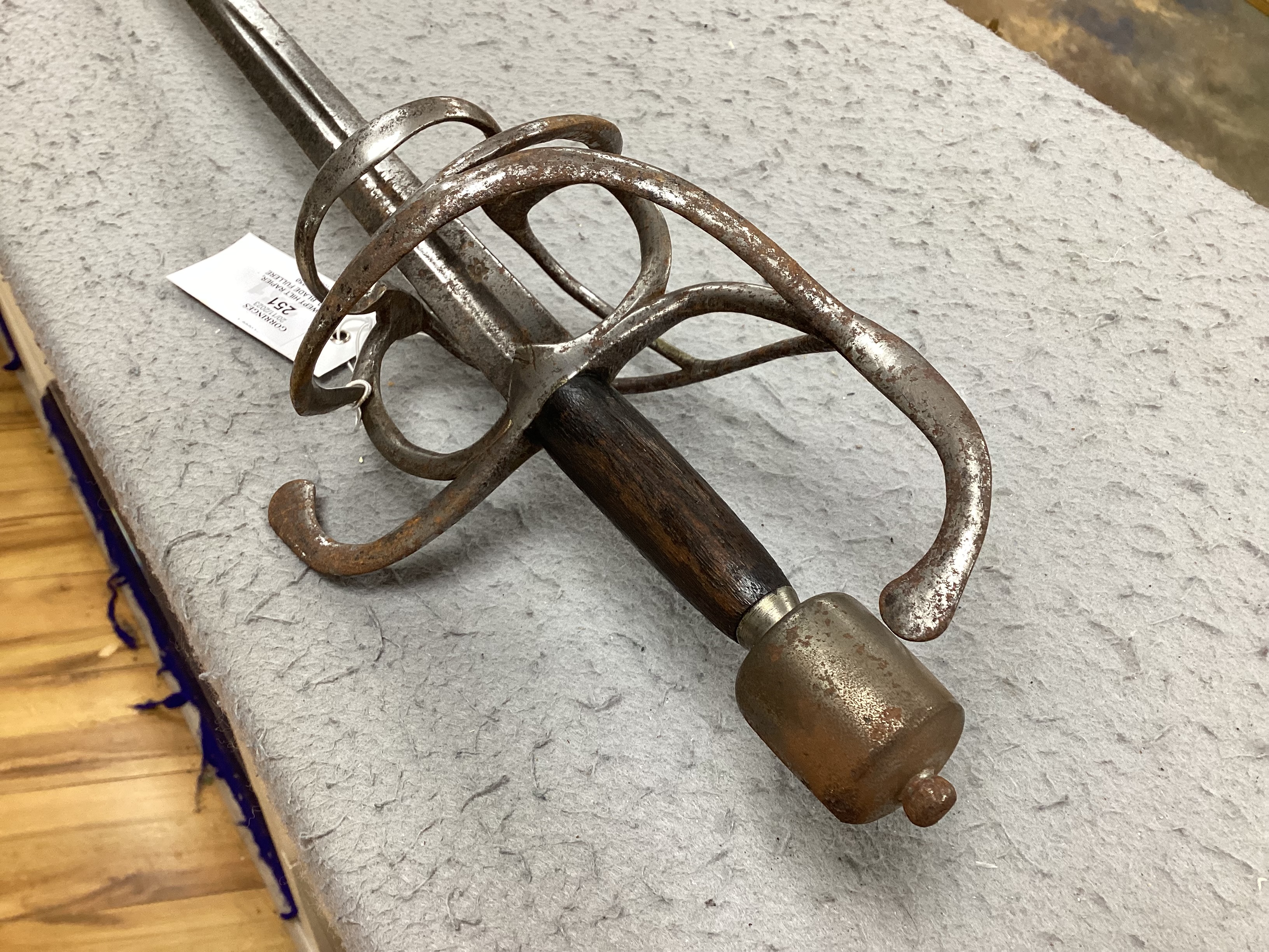 A swept hilt rapier, c.1620, blade fullered at the forte, iron guard of conventional form with later pommel and wooden grip, blade 113cm